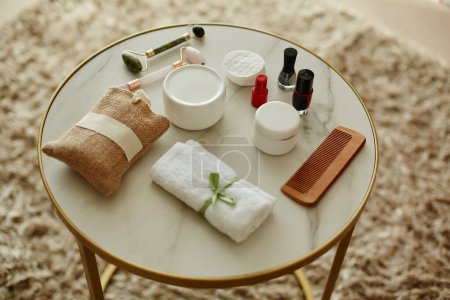 Photo for Top view background image of beauty supplies laid on round marble table in cozy setting, copy space - Royalty Free Image