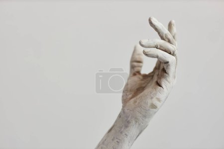 Photo for Minimal closeup of male hand covered in white paint or plaster, human art form, copy space - Royalty Free Image