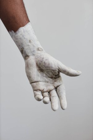 Photo for Vertical closeup of male hand covered in white paint, minimal - Royalty Free Image