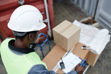 Photo for Top view at worker pushing cart with boxes at shipping docks, copy space - Royalty Free Image