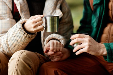 Photo for Close up of loving active couple enjoying hot drinks during hike - Royalty Free Image