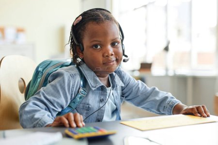 Photo for Portrait of cute black girl playing home office work with calculator and looking at camera - Royalty Free Image