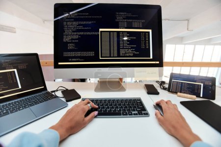 Photo for First person view of female software developer coding on computer - Royalty Free Image
