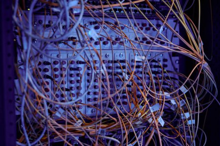 Photo for Close up background image of server cabinet with cables and wires in purple neon light, copy space - Royalty Free Image