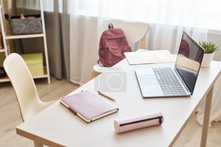Photo for Background image of students desk at home with open laptop and backpack, schoolgirl workplace, copy space - Royalty Free Image