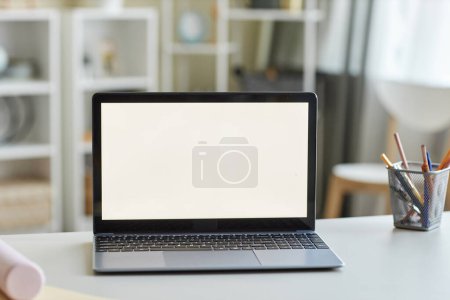 Photo for Close up of open laptop with blank white screen mockup on students desk, copy space - Royalty Free Image