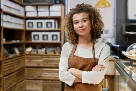 Photo for Portrait of young smiling bakery owner crossing arms and looking at camera - Royalty Free Image