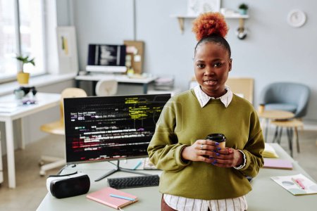Photo for Waist up portrait of black young woman as software programmer smiling at camera in office, copy space - Royalty Free Image