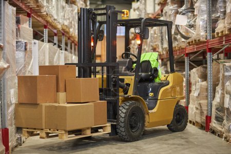 Photo for Background image of forklift truck carrying boxes in warehouse - Royalty Free Image