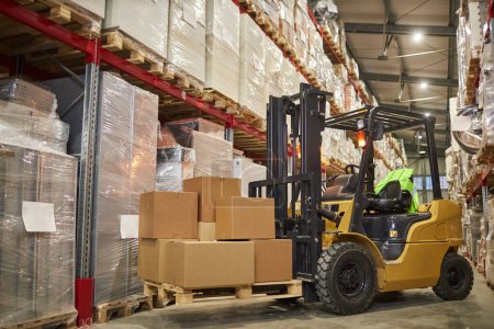 Photo for Background image of forklift truck in warehouse interior with tall shelves, copy space - Royalty Free Image