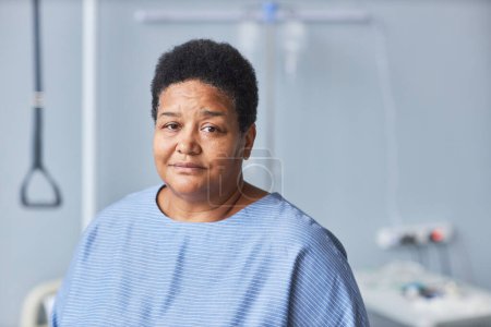 Photo for Minimal portrait of black senior woman looking at camera in hospital room, copy space - Royalty Free Image