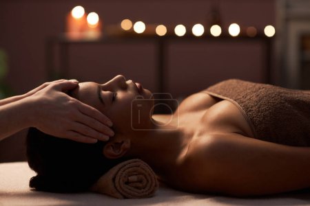 Photo for Young woman getting relaxing full body and face massage in spa salon - Royalty Free Image