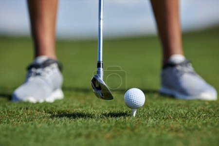 Téléchargez les photos : Gros plan de jeune femme noire jouant au golf sur l'herbe verte et frappant la balle avec le club visant un tir parfait, l'espace de copie - en image libre de droit