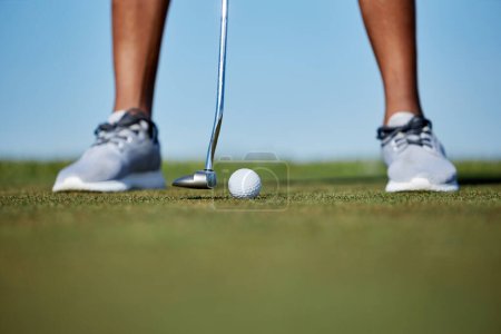 Photo for Macro shot of unrecognizable person playing golf with focus on golf club hitting ball on grass - Royalty Free Image