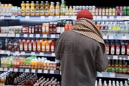 Foto de Vista trasera de un viejo irreconocible comprando en el supermercado y comprando comestibles, espacio para copiar - Imagen libre de derechos