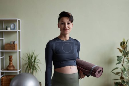 Photo for Minimal waist up portrait of pregnant young woman looking at camera ready for home workout - Royalty Free Image