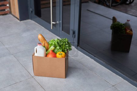 Photo for Background image of box with fresh groceries outdoors on house porch, copy space - Royalty Free Image
