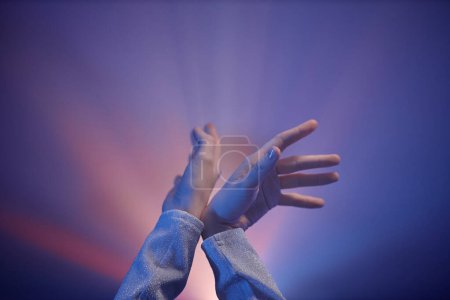 Photo for Minimal closeup of female hands dancing in violet neon light, copy space - Royalty Free Image