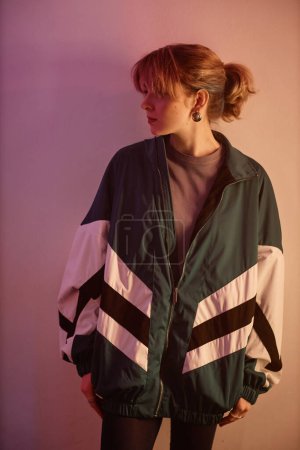 Photo for Vertical portrait of young girl wearing oversize retro jacket in 80s aesthetic style, side view - Royalty Free Image