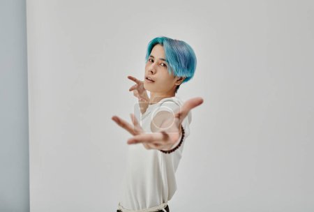 Téléchargez les photos : Portrait de jeune danseuse aux cheveux bleus dansant seule sur fond blanc - en image libre de droit