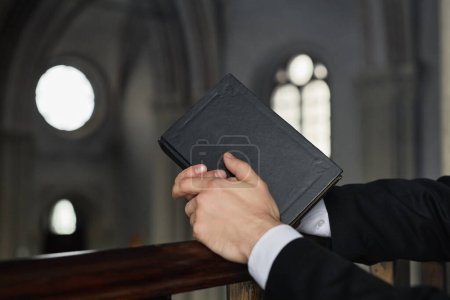 Close-up of pastor with Bible standing in old baptist church