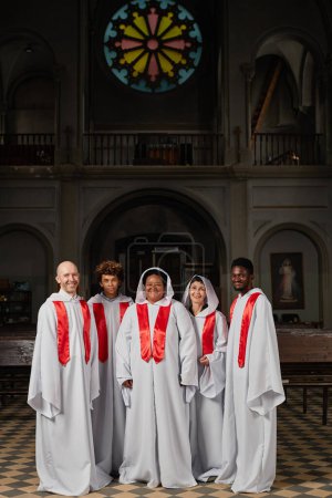Photo for Vertical image of people from church choir in standing in white costumes in baptist church - Royalty Free Image