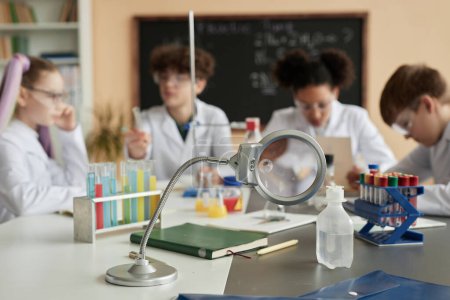 Photo for Close up of laboratory equipment in science class with group of children in background - Royalty Free Image
