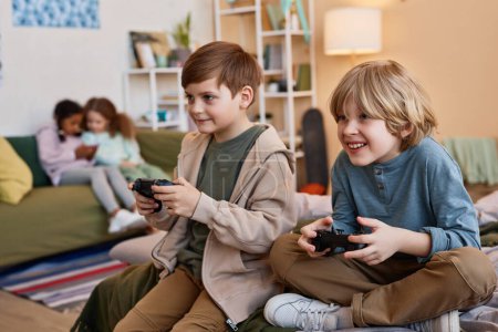 Photo for Portrait of two excited boys playing videogames together, copy space - Royalty Free Image