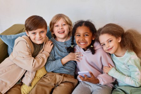 Photo for Group of cheerful little kids looking at camera and smiling indoors - Royalty Free Image