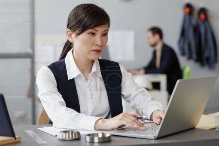 Photo for Portrait of young Asian woman as female engineer using laptop at workplace in office - Royalty Free Image