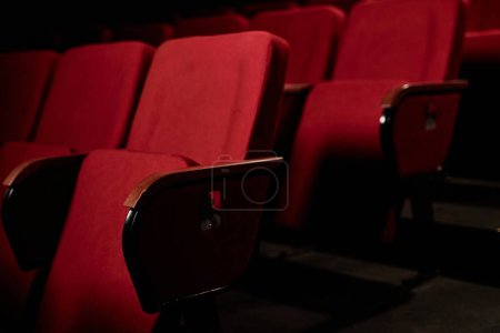 Photo for Close up background image of red chairs in audience at dark theater copy space - Royalty Free Image