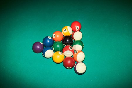 Photo for Minimal high angle view of billiard balls in triangle on green canvas table shot with flash copy space - Royalty Free Image