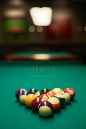 Photo for Vertical background image of billiard balls set in triangle on green table copy space - Royalty Free Image