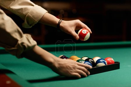 Photo for Minimal side view closeup of male hands setting up billiard balls on pool table copy space - Royalty Free Image