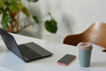Photo for Closeup background image of simple workplace with open laptop on desk, copy space - Royalty Free Image