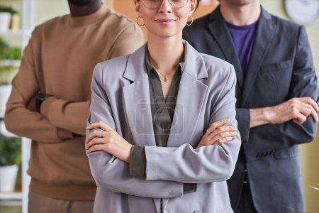 Photo for Closeup of professional business team in office posing confidently with arms crossed - Royalty Free Image