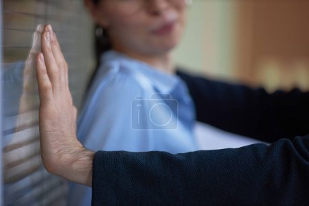 Photo for Closeup of man pushing woman against wall in office, workplace harassment scene - Royalty Free Image