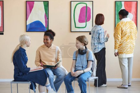 Photo for Diverse group of teenagers enjoying discussion in modern art gallery or museum - Royalty Free Image