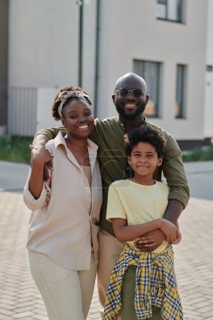 Photo for Vertical portrait of African American family of three spending time outdoors - Royalty Free Image