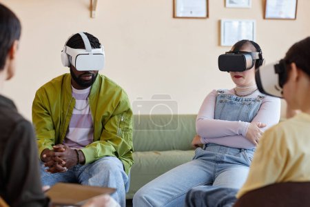 Photo for Group of young people in VR glasses sitting at psycho session during meeting with psychologist - Royalty Free Image