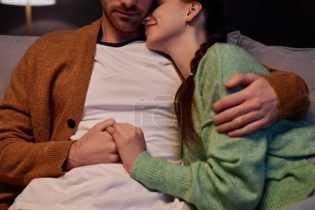 Foto de Primer plano de pareja joven abrazando cariñosamente disfrutando del tiempo juntos en casa - Imagen libre de derechos