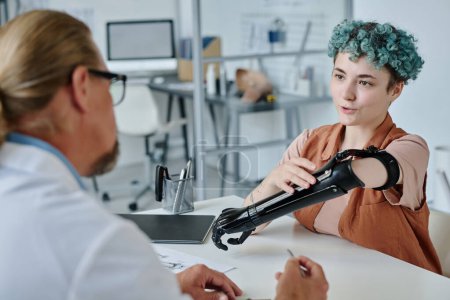 Photo for Portrait of young woman with colored hair consulting with prosthetist in orthology clinic - Royalty Free Image