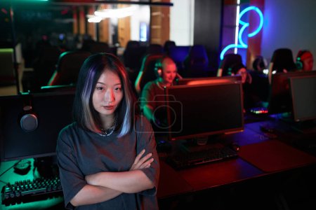 Photo for Waist up portrait of young Asian woman posing confidently in gaming club and looking at camera, copy space - Royalty Free Image