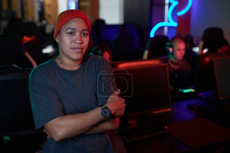 Photo for Waist up portrait of confident African American woman looking at camera standing in gaming club, copy space - Royalty Free Image