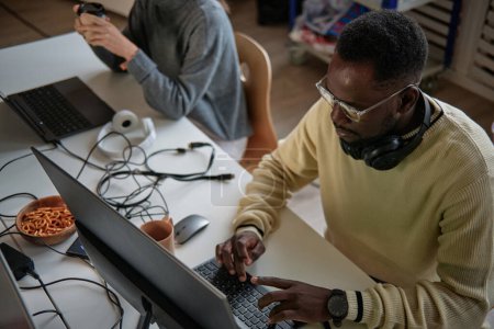 Black man working as software developer in startup company