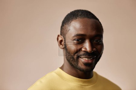 Photo for Minimal portrait of adult Black man looking at camera in studio against neutral background, copy space - Royalty Free Image