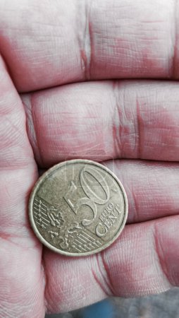 50 euro cent coin on the palm of a man