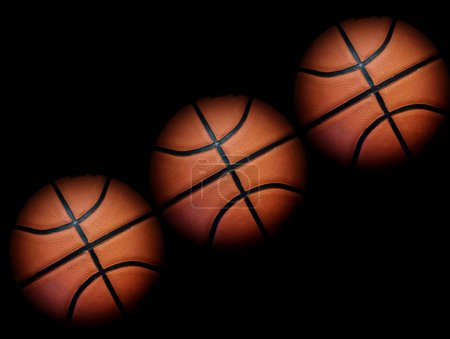 Three basketballs arranged diagonally  black 