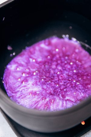 Purple granules are heated in black wax melter. Eyebrow tools