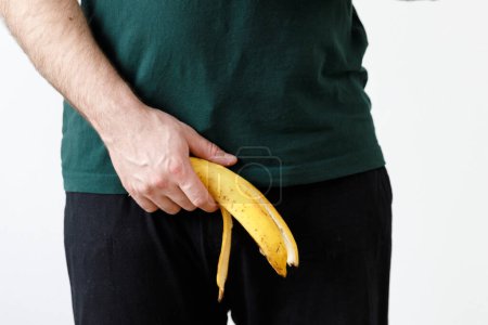Photo for Man is holding banana. Men's health, impotence, potency - Royalty Free Image